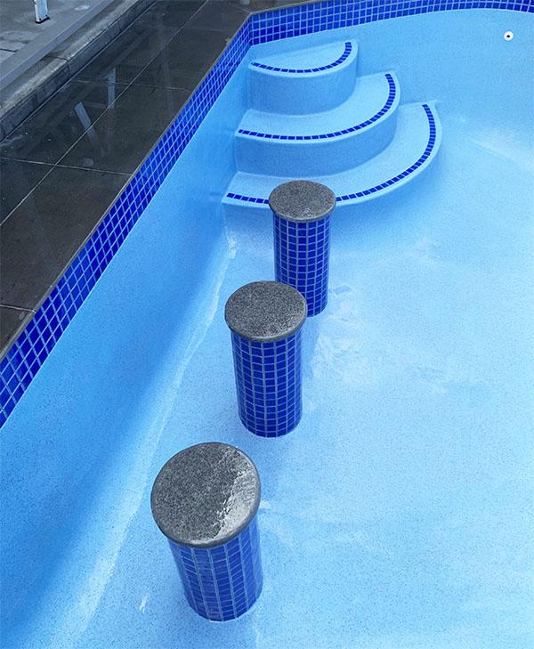 Swimming pool with bar stools